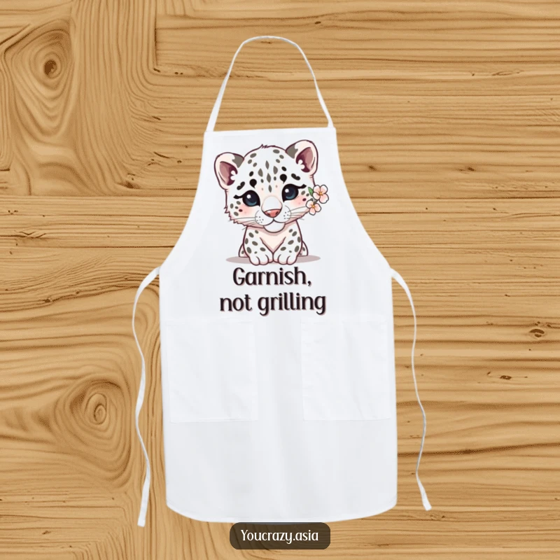 Funny snow leopard apron showing a shy leopard with a delicate flower behind its ear, peeking out, adding gentle humor to the kitchen attire.