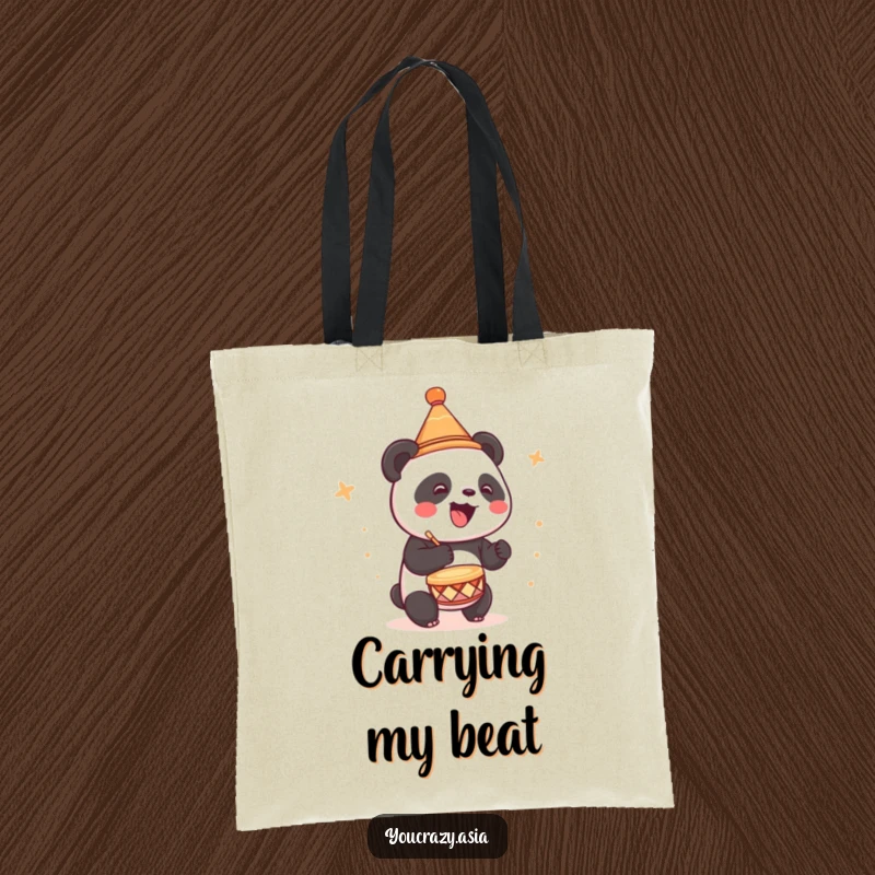 Funny tote bag showing a cute panda wearing a tiny party hat, joyfully drumming a lively beat.